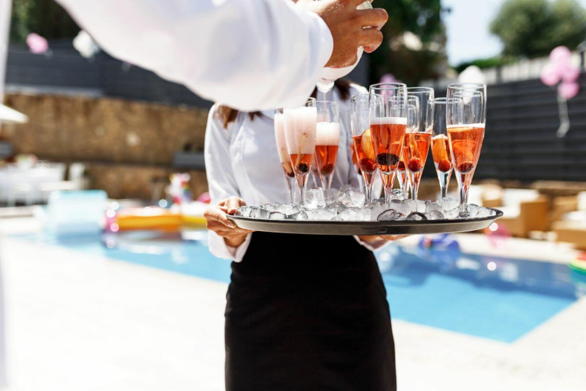 private chef serving champagne poolside at luxury villa ibiza